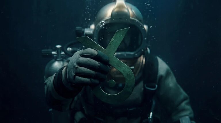 Diver holding the MonkeyFish logo underwater, representing SEO services